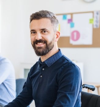 demo-attachment-525-young-businessman-in-wheelchair-with-colleagues-EWTN4AC